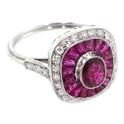 Platinum ring set with central oval ruby, halo of calibre cut rubies and halo of diamonds, with diamond shoulders