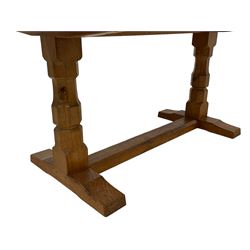 Mouseman - adzed oak 6ft refectory dining table, rectangular plank top, raised on twin octagonal end supports on sledge feet united by floor stretcher, carved with fat mouse signature, by the workshop of Robert Thompson, Kilburn