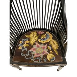 Early 20th century ebonised elbow chair, arched cresting rail with slat back, seat upholstered in foliate tapestry fabric with studwork, fluted frieze rail, raised on square tapering supports with spade feet
