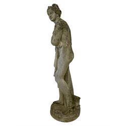 Weathered composite stone garden statue in the form of a classically draped female modelled as Venus Italica after Antonio Canova