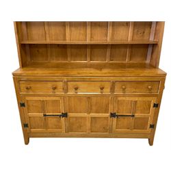Rabbitman - adzed oak dresser, raised two tier plate rack over three drawers and three panelled cupboards, with wrought metal hinges and fittings, carved with rabbit signature, by Peter Heap of Wetwang 