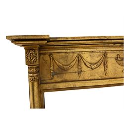 Regency design gilt framed mirror, the projecting cornice over frieze decorated with linen swags and central urn, bevelled mirror plate flanked by turned columns with foliate decoration