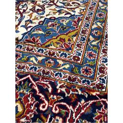 Hand knotted Iranian Kashan red ground carpet, busy red field centred by floral medallion of blues and ivory 390cm x 300cm