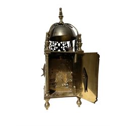 English - 20th century 8-day replica Lantern clock, with a French twin train striking movement and lever platform escapement, striking the hours and half hours on a visible silvered bell, with a silvered chapter ring with Roman numerals and gothic steel hands, under an associated glass dome and 7” spun brass base.