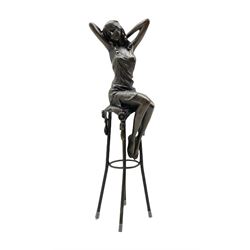 Art Deco style bronze figure of a lady with hands raised behind her head, seated on a stool, with foundry mark, H28cm