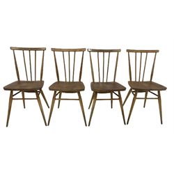 Set four Ercol blonde beech and elm chairs, the spindle back over elm seat, raised on turned supports 