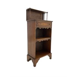 20th century mahogany open bookcase, with one inlaid frieze drawer over one fixed drawer, raised on bracket supports 