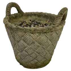 Cast stone garden planted in the form of a weaved basket with carrying handles