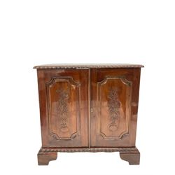 Mahogany low cupboard hi fi cabinet, the top with gadroon moulded edge over two panelled doors with floral carving, raised on bracket supports W71cm