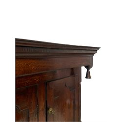 Georgian and later oak court cupboard, the projecting frieze over three panelled cupboards, three drawers and two cupboards, opening to reveal one shelf, raised on bracket supports  