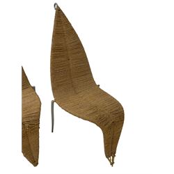 Set four late 20th century 'leaf' rattan chairs, the banana leaf shape in s curve, raised on splayed back supports