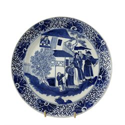 19th century Chinese blue and white plate, the central reserve painted with fighting warriors in a mountainous landscape, within scroll work borders, D24cm, together with a similar plate painted with figures by a building (2)