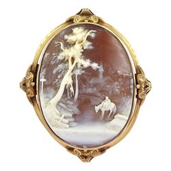 19th century gold shell cameo brooch, carved in high relief depicting a figure on horseback beneath a tree
