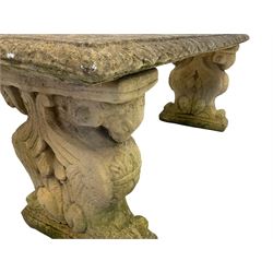 19th century design composite stone three-piece garden bench, the rectangular seat with acanthus leaf border, the end supports in a scrolled foliate form enclosing poppies with rams head capitals
