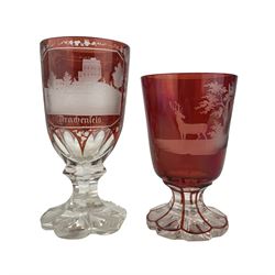 19th century Bohemian ruby overaly glass goblet, the funnel bowl engraved with a Stag in a woodland landscape, on faceted foot H13.5cm, a similar goblet engraved with views of German castles 'Rheinfels' and 'Stolzenfels', ruby overlay cut glass vase and scent bottle with gilt decoration (4)