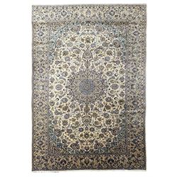 Persian Kashan ivory ground carpet, overall floral design, the filed decorated with central star motifs and surrounded by scrolling foliage branches, decorated all over with stylised plant motifs, the guarded decorated with trailing floral pattern