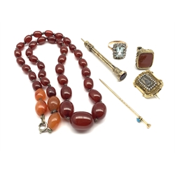 Amber bead necklace L46cm, pinchbeck fob seal, 19th century mourning brooch with hair panel, gilt metal seal top pencil and two other items 