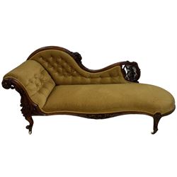 Victorian mahogany framed chaise longue, scrolled back and arm carved and pierced with scrolling vines and grapes with ribbon-twist mouldings, sprung seat and buttoned back upholstered in citrine velvet, apron moulded and carved with curling foliate decoration, on cabriole supports with ceramic castors