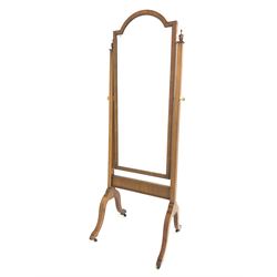 Georgian style walnut cheval dressing mirror, the swing mirror with stepped arched top on square tapered uprights with urn finials, four splayed supports with castors 