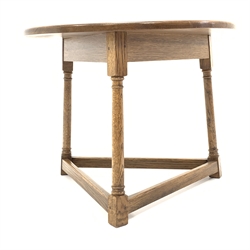  Medium oak circular cricket table, with three turned supports united by stretchers, 66cm x 66cm, H52cm  