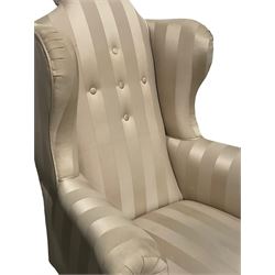 Victorian wingback armchair upholstered in later fabric, raised on cabriole supports 