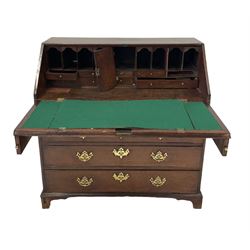 George III oak bureau, the fall front enclosing a fitted interior over two short and three long graduated drawers, raised on bracket supports 