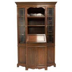 Late 19th century walnut secretaire cabinet, the projecting moulded cornice with dentil, the central section fitted with shelves and fall front with drawers and pigeon holes to the interior, double cupboard below, the flanking uprights fitted with astragal glazed doors above panelled cupboard doors, lower moulded edge over shape aprons and bracket feet