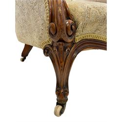 19th century walnut framed armchair, curved back upholstered in buttoned floral pattern fabric, scroll carved arm terminals and shaped supports, foliate carved cabriole feet with brass and ceramic castors