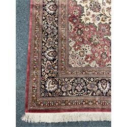 Finely knotted Persian Qom silk rug, overall pink ground with ivory field, the field with central cusped medallion profusely decorated with interlacing foliate and stylised flower heads, multiple band boarder, the main band decorated with a series of stylised motifs and trailing foliage, the outer guard with signature panel 
