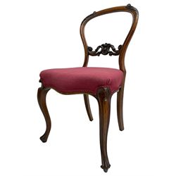 Set of six Victorian rosewood dining chairs, the balloon back carved with foliage scrolls, cartouche carved middle rail with extending scrolls, the seats upholstered in pink fabric, on carved cabriole supports with scrolled terminals 