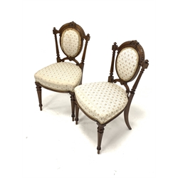 Pair of Victorian walnut upholstered hall chairs, floral carved cresting rail and fluted back supports, raised on turned and fluted front supports, W45cm
