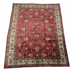 Larger persian hand knotted red ground rug, the central field with all over floral design enclosed by border 400cm x 304cm