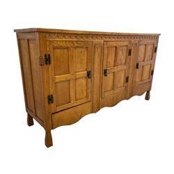 'Gnomeman' adzed oak dresser base, rectangular top over three cupboards enclosed by panelled doors each above drawer, carved linen fold uprights, carved with gnome signature, by Thomas Whittaker of Littlebeck, W155cm, H86cm, D44cm