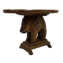 Mid-20th century carved teak and mahogany occasional table, oval top supported by carved lion figure