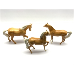 Three Beswick horses in palomino gloss comprising Arab type No. 1261, first version, Stocky Jogging Mare  no. 855 third version and an Arab horse No.1265