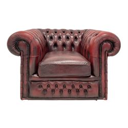 Chesterfield armchair, upholstered in red buttoned back leather, raised on castors 