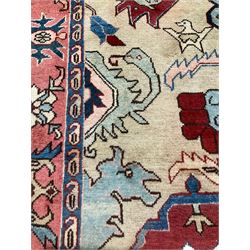 Persian Heriz rug, ivory ground field with stylised plant and geometric decoration, the border decorated with stylised flower head motifs surrounded by guards with repeating Boteh motifs