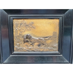 Pair of relief cast metal plaques modelled as hunting dogs in landscapes, in ebonised frames, 125cm x 131cm 
