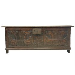 18th century oak coffer or chest, rectangular hinged top with moulded edge, fitted with candle box, the front carved with stylised plant motifs, raised on stile supports