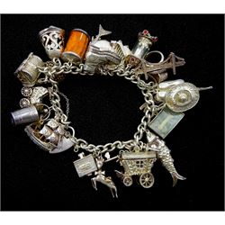 Silver charm bracelet with twenty six charms including clock, hedgehog, shark, treasure chest and Bible, hallmarked or tested 