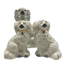 Staffordshire pottery spaniel with chain and gilding together with pair of Staffordshire style Beswick spaniels (3) max H28cm
