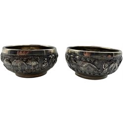 Pair of Indian white metal salts by Grish Chunder Dutt, Bhowanipore Calcutta embossed with village scenes, four various silver serviette rings, two silver decanter labels, Charles Horner thimble, one other, silver teaspoon and a silver handled pastry server 