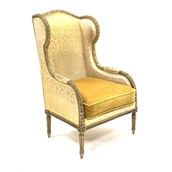 19th century giltwood wing back armchair with leaf and bead carved decoration on fluted turned supports