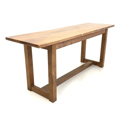 Late 20th century yew wood refectory style table, rectangular top raised on square supports united by a central stretcher