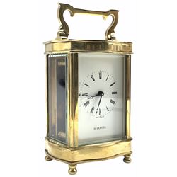 A mid-20th century English eight-day timepiece carriage clock with a lever platform escapement, overcoil balance spring with timing screws, Louis XV Doucine case on four turned bun feet, bevelled glass panels to the case and an oval glass panel to the top of the case, white enamel dial with Roman numerals, minute markers and steel moon hands, dial inscribed 