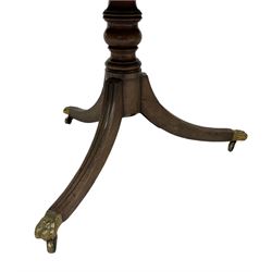 Regency mahogany tilt top table, the tilt top over one turned column leading into three splayed supports, terminating in hairy paw castors 