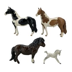 Royal Doulton horses comprising Piebald Pinto Pony, Skewbald Pinto Pony, Shetland Pony and grey foal (4)