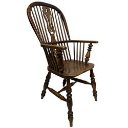 Early 19th century Windsor armchair, the splat and spindle back over elm seat, raised on turned supports, united by stretchers
