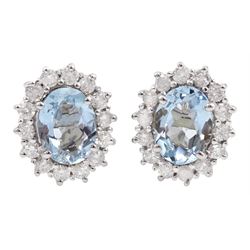 Pair of 18ct white gold oval aquamarine and round brilliant cut diamond cluster stud earrings, stamped, total aquamarine weight approx 1.70 carat, total diamond weight approx 0.60 carat