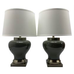Pair of smokey crackle glazed table lamps, each of squat baluster form, raised upon square brushed bronze base, H58cm 